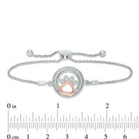 1/15 CT. T.W. Diamond Open Circle with Paw Print Bolo Bracelet in Sterling Silver and 10K Rose Gold (1 Line) - 9.5"|Peoples Jewellers