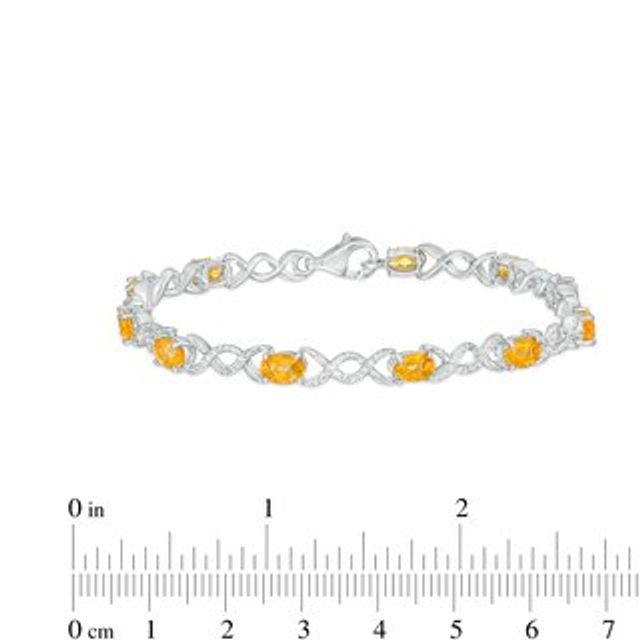 Oval Citrine and 0.18 CT. T.W. Diamond Infinity Ribbon Link Line Bracelet in Sterling Silver – 7.5"|Peoples Jewellers