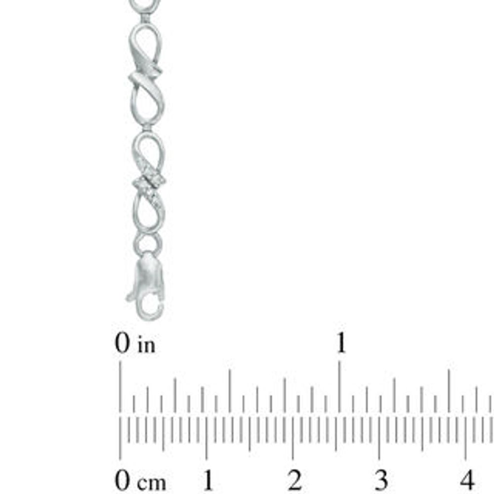 Previously Owned - 0.10 CT. T.W. Diamond Infinity Ribbon Link Bracelet in Sterling Silver - 7.25"|Peoples Jewellers