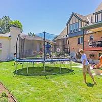 Skywalker Trampolines 15 ft Oval Trampoline with Kickback, Bounce and Navy Spring Pad