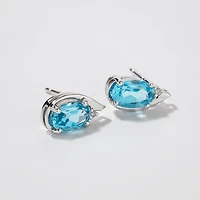 Oval Blue Topaz Earrings in 10K White Gold