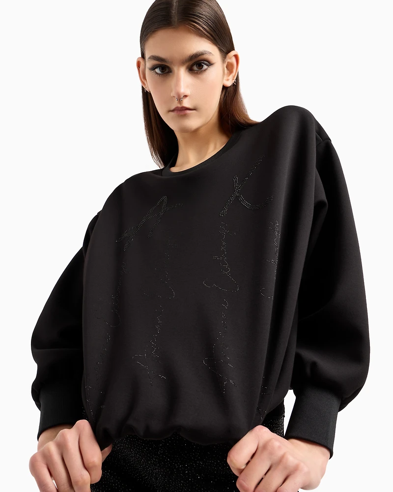 Oversized sweatshirt with wavy bottom and rhinestones