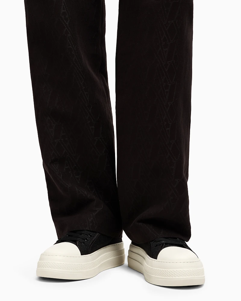 Pleated trousers with allover logo