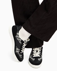 Sneakers with allover logo inserts