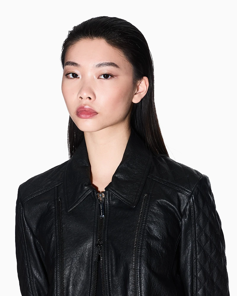 Leather jacket with quilted sleeves