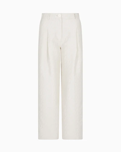 Pleated trousers with allover logo
