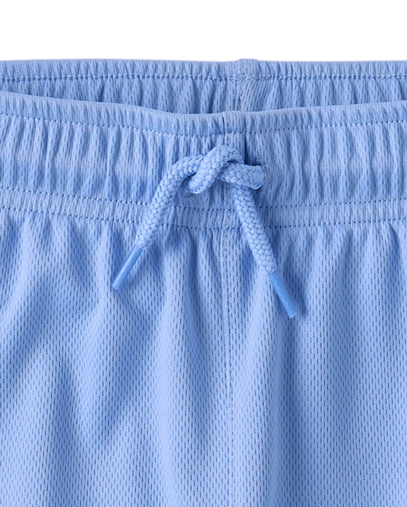 Short de sport enfant à séchage rapide et bandes latérales en maille