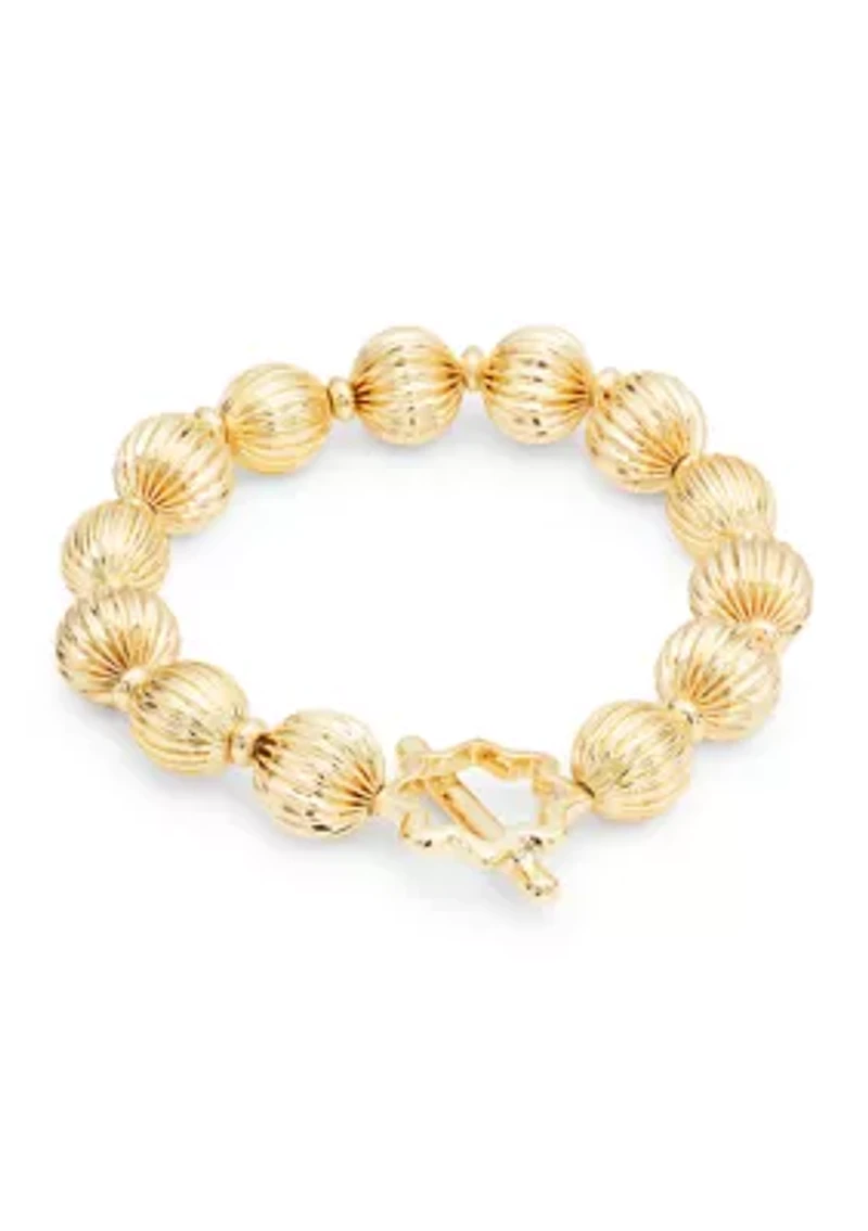 Gold Tone Textured Bead and Quatrefoil Toggle Stretch Bracelet
