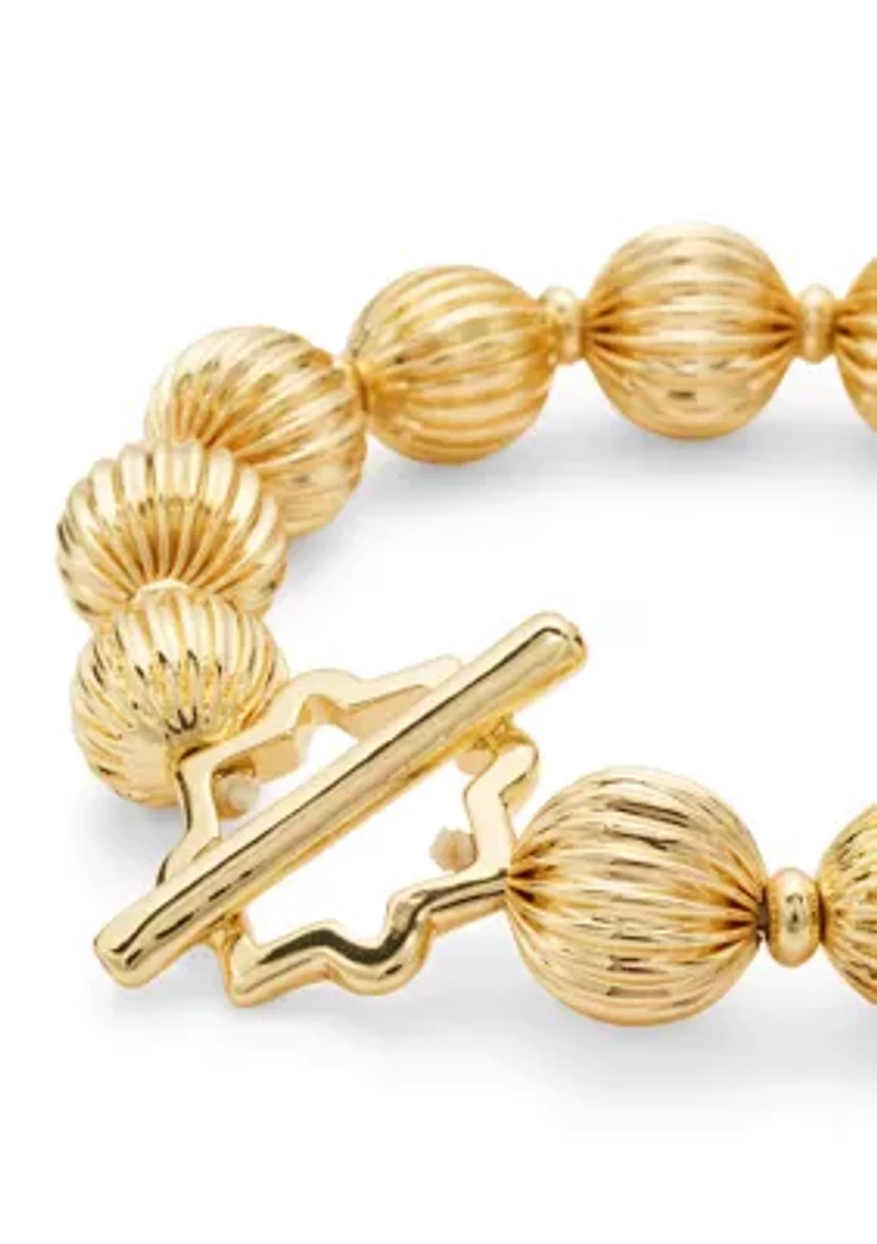 Gold Tone Textured Bead and Quatrefoil Toggle Stretch Bracelet