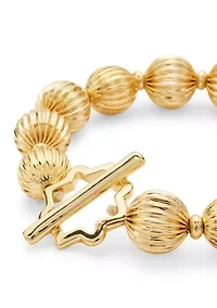 Gold Tone Textured Bead and Quatrefoil Toggle Stretch Bracelet