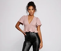 Pleated and Poised Peplum Blouse