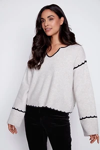 Le pull brodé au dos