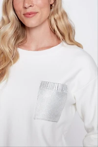 Le pull à bordure métallique