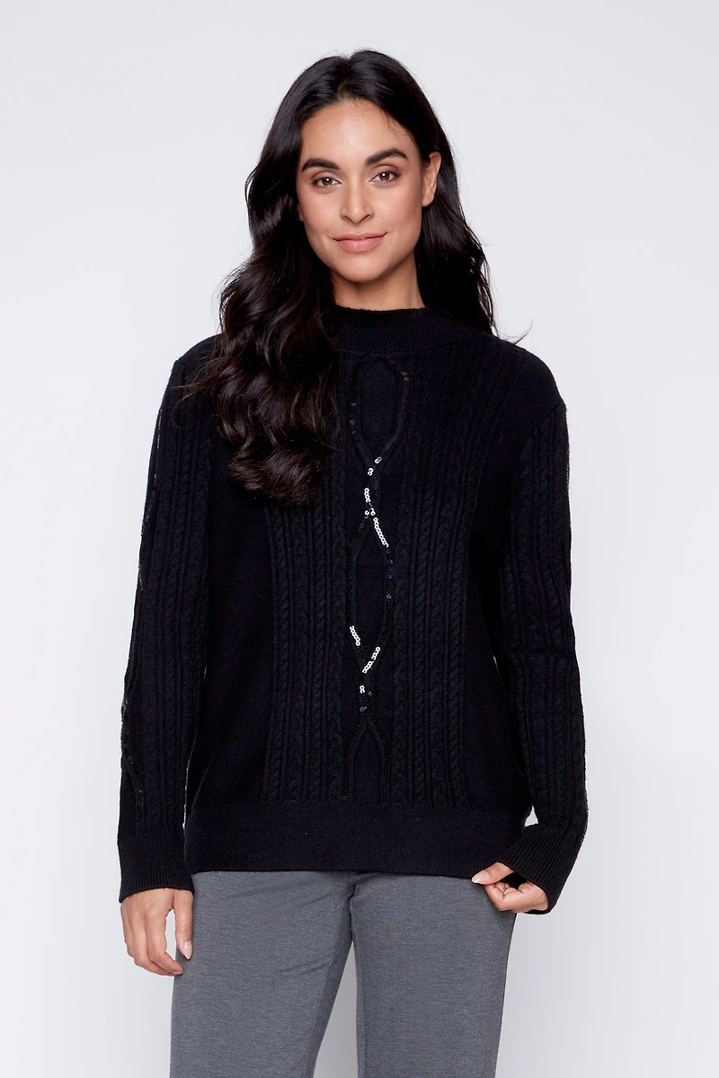 Le pull torsadé à détails pailletés
