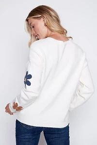 Le pull avec fleurs bouclé