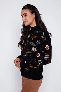 Le pull brodé de feuilles florales