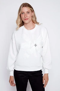 Le pull fleuri avec appliques diamantées