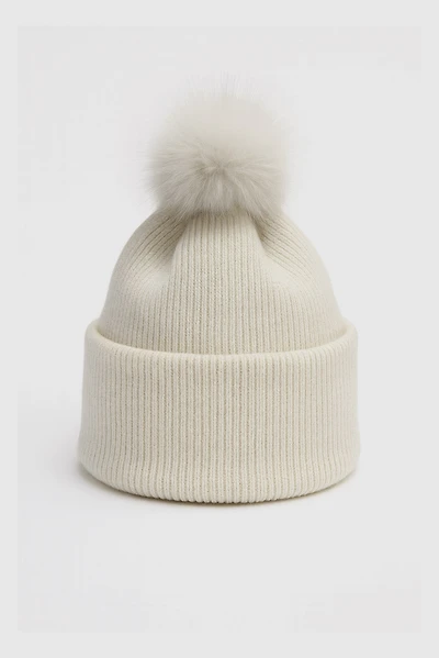 Knit hat with fur pom