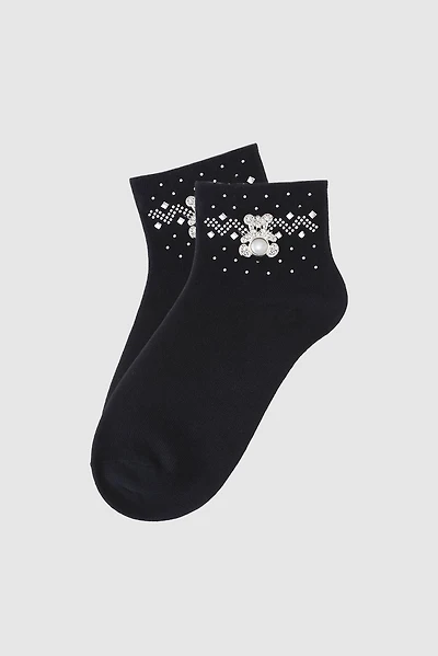 Les chaussettes brodées de perles et d'ourson en peluche