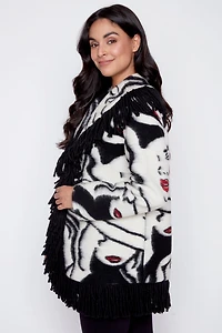 La veste en laine bouillie à imprimé visage et franges