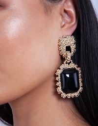 Boucles d’oreilles pendantes en émail noir à texture dorée