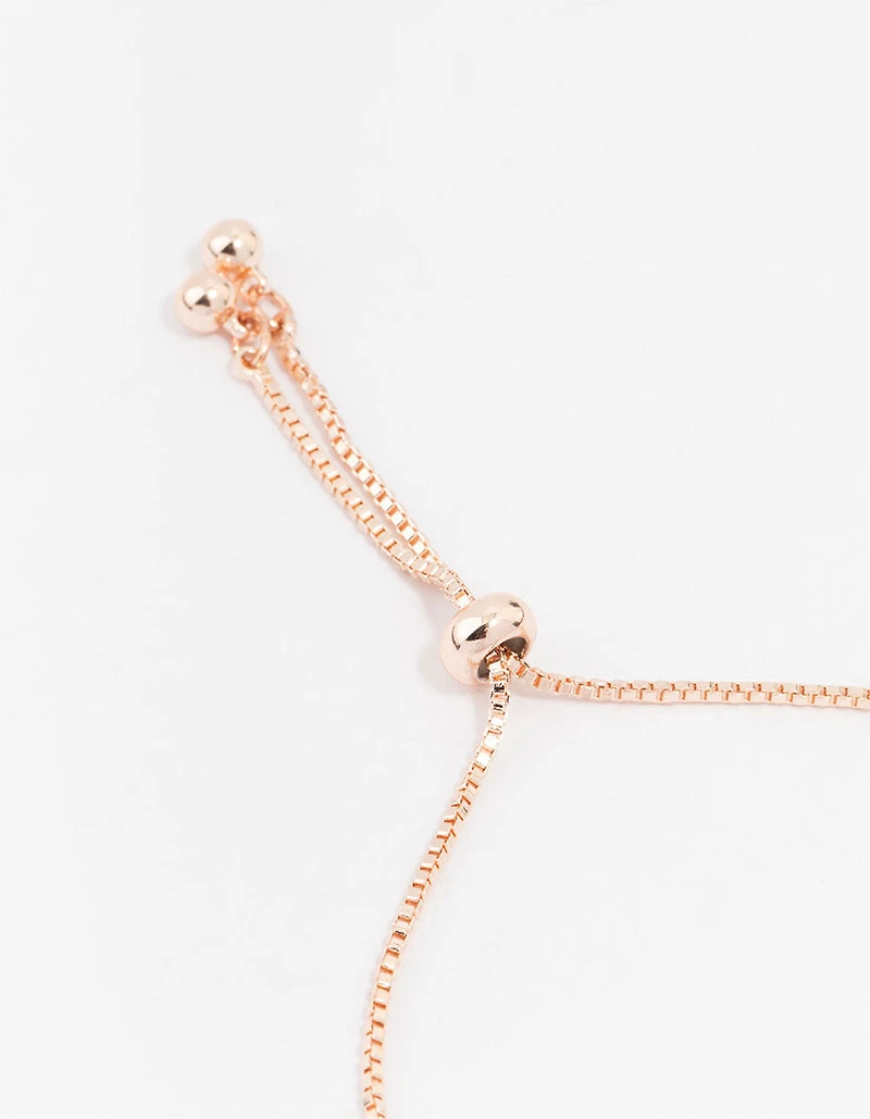 Bracelet à fermoir à bascule en forme de cœur, plaqué or rose, orné d'une grande nacre et de mini zirconiums cubiques.