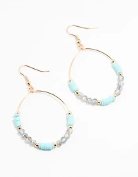 Boucles d’oreilles or, bleues perlées et à cerceau en forme de disque