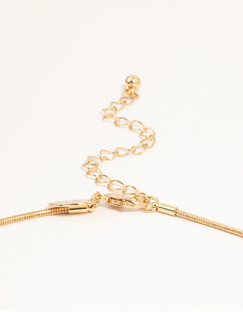 Collier et boucles d’oreilles en or délicats avec nœud