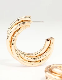 Boucles d’oreilles en anneau torsadé en or en fusion