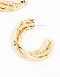 Boucles d’oreilles en anneau torsadé en or en fusion
