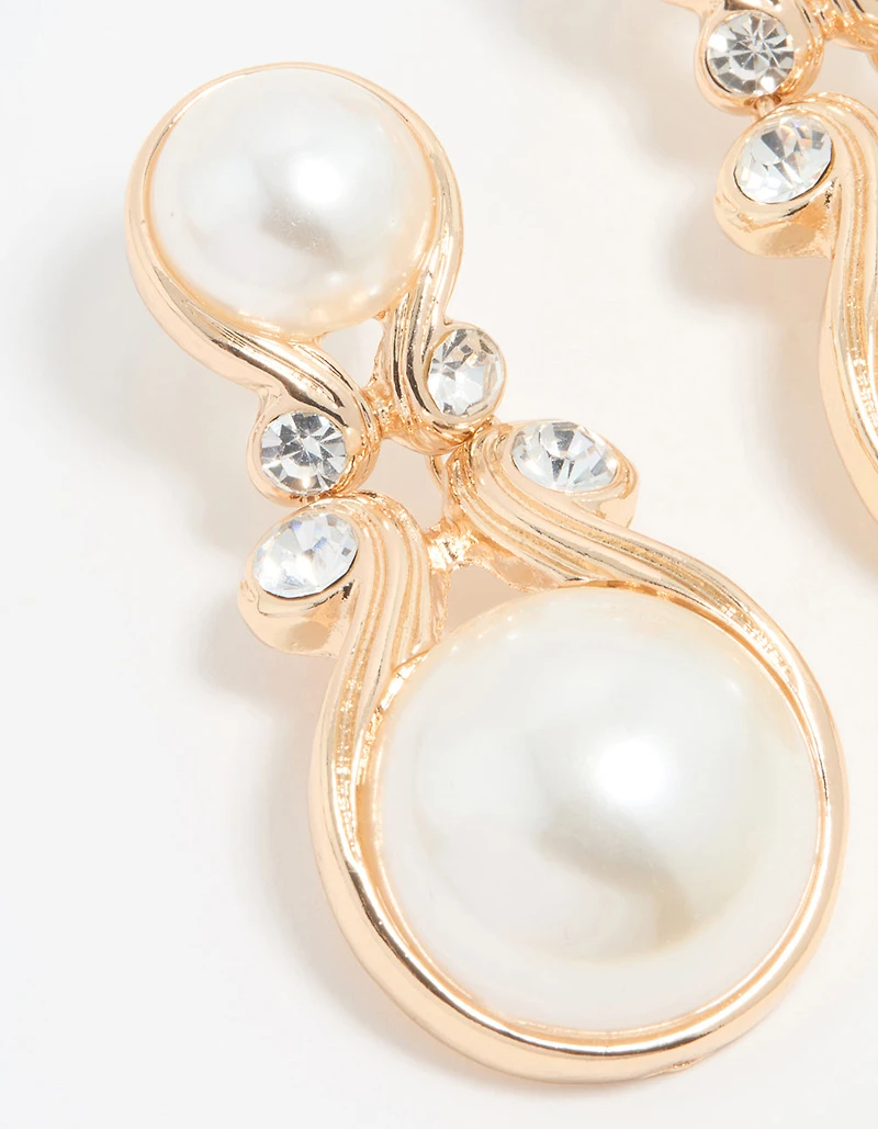 Boucles d’oreilles tombantes en perle dorée Diamante