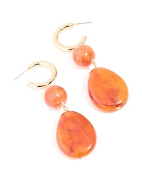 Boucles d’oreilles pendantes ovales en résine orange dorée