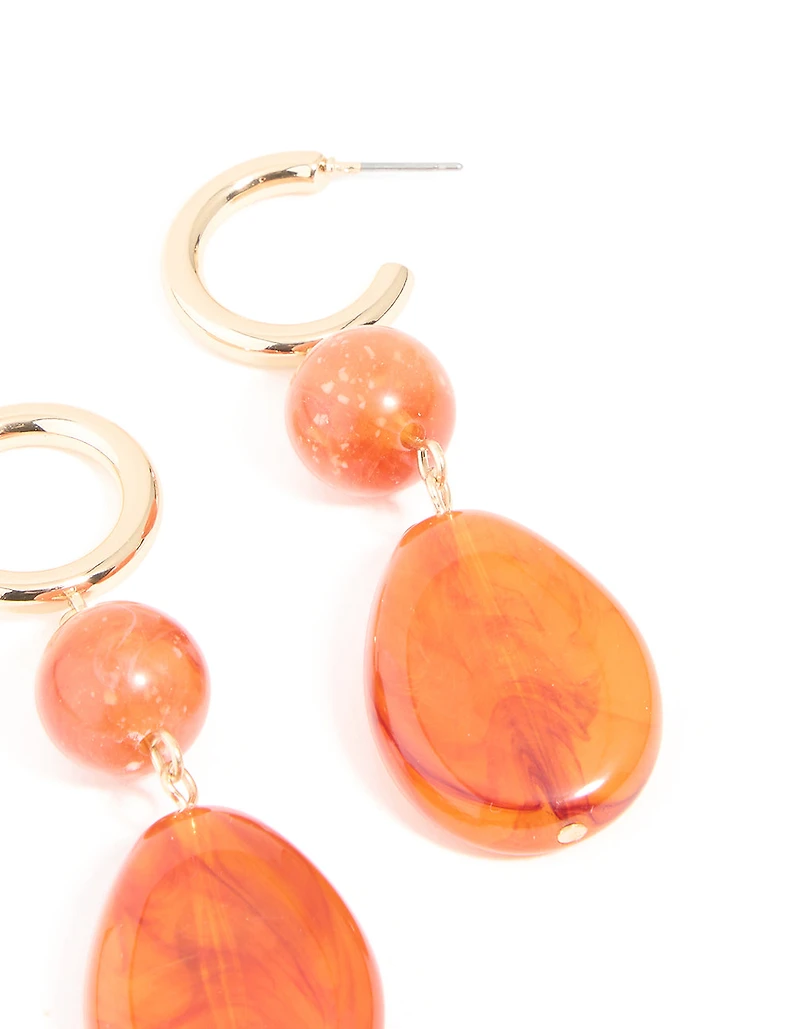 Boucles d’oreilles pendantes ovales en résine orange dorée
