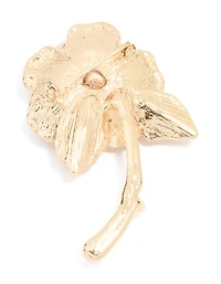 Broche en rose dorée qui fleurit