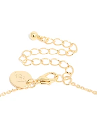 Collier croix cubique en zirconie plaqué or avec une baguette