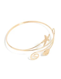 Étoile de mer dorée et manchette de bras en coquillage