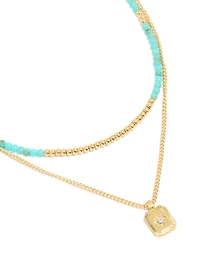 Collier à perles bleues plaquées or et pendentif céleste en couches