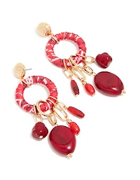 Boucles d'oreilles pendantes dorées et rouges, ornées de perles et enveloppées de papier