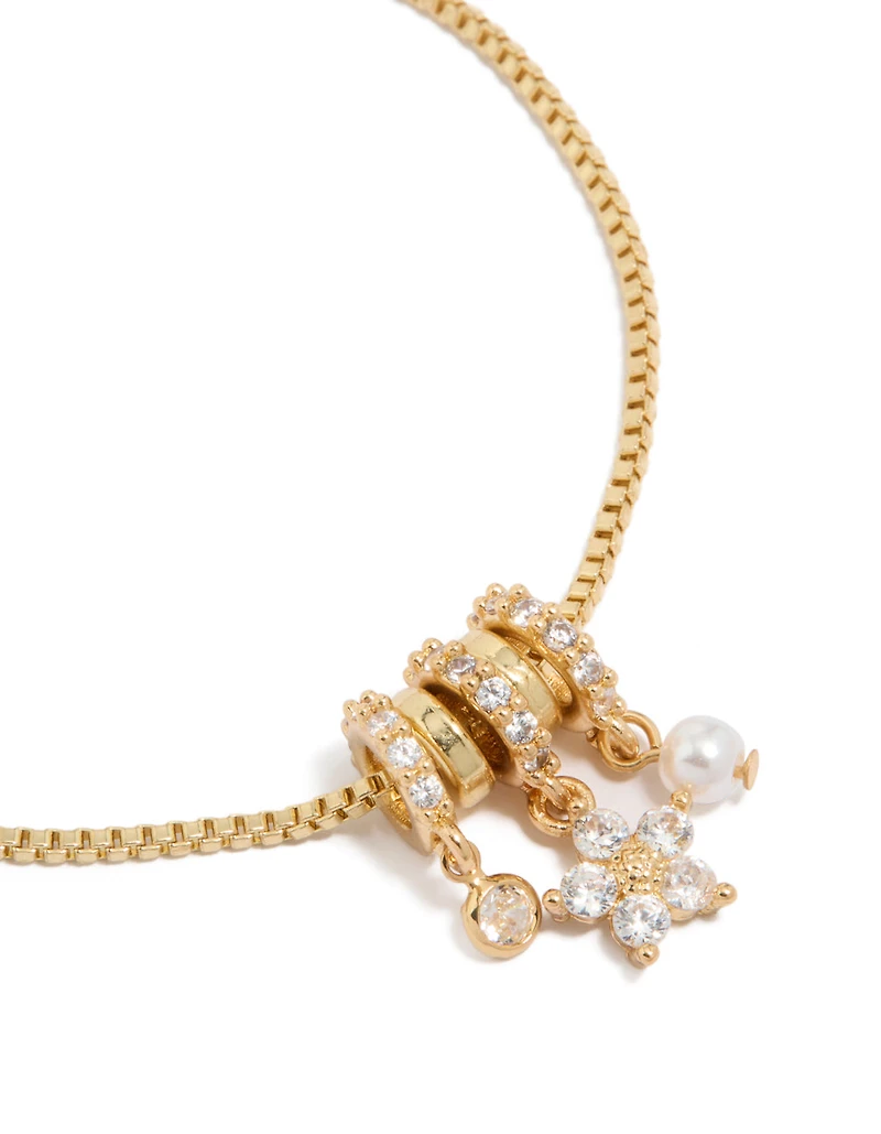 Bracelet à fermoir à bascule orné de breloques rondelles en zircon cubique, fleur et perle, plaqué or
