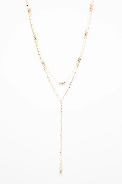 Le collier or deux chaînes et billes