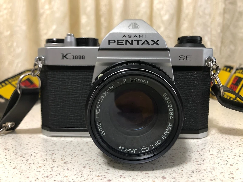 Pentax K1000 35mm SLR Film Camera Kit w/50mm Lens, Pentax Camera Cover, Vivitar 3500 Flash