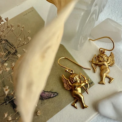 The Amores Raw Brass Cupid Drop Earrings