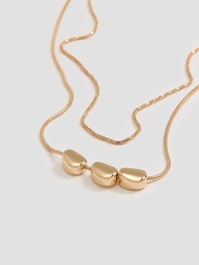 Collier court à deux chaînes avec pendentifs style galet