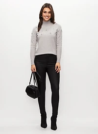 Pull à perles et cristaux et jean noir étroit