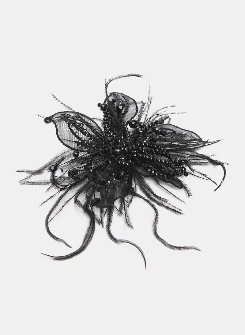 Broche à paillettes et plumes