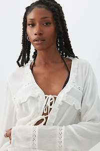 Blouse nouée à l'avant en tissu froissé volants