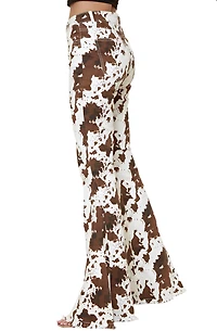SAINTS  AND HEARTS: COW PRINT FLARED DENIM PANTS