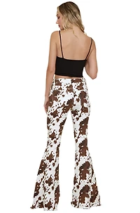 SAINTS  AND HEARTS: COW PRINT FLARED DENIM PANTS