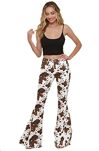 SAINTS  AND HEARTS: COW PRINT FLARED DENIM PANTS