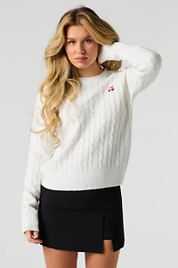 Chandail en tricot torsadé avec motif brodé